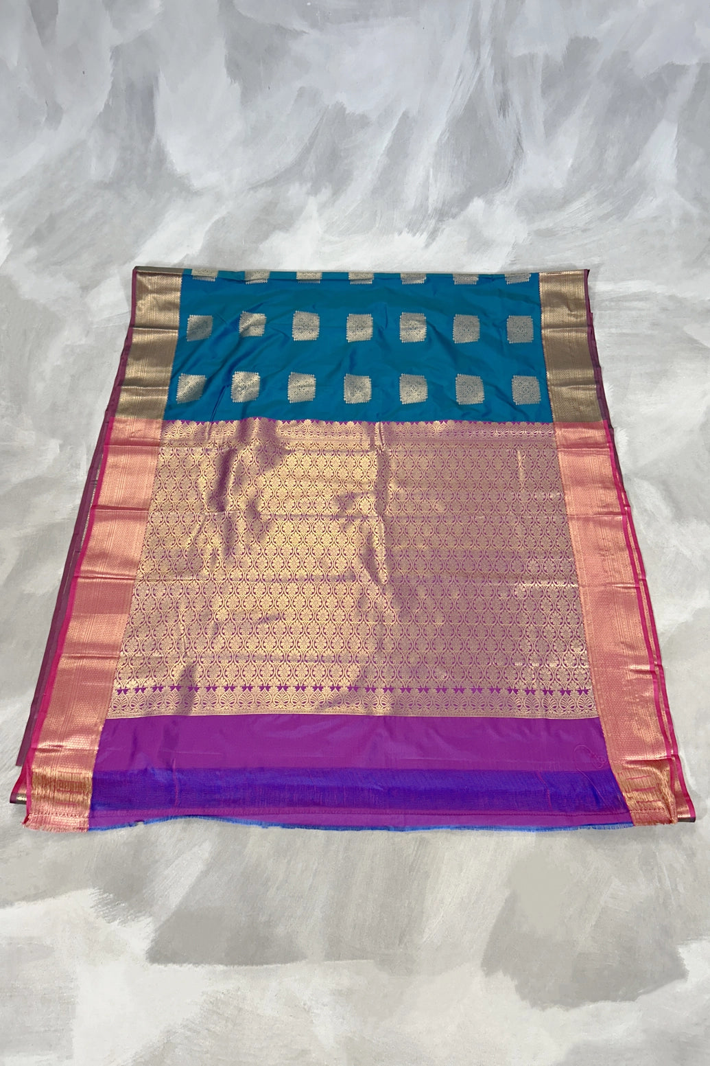 Peacock Blue Soft Silk Saree with Gold Zari Buttas and Traditional Floral Border