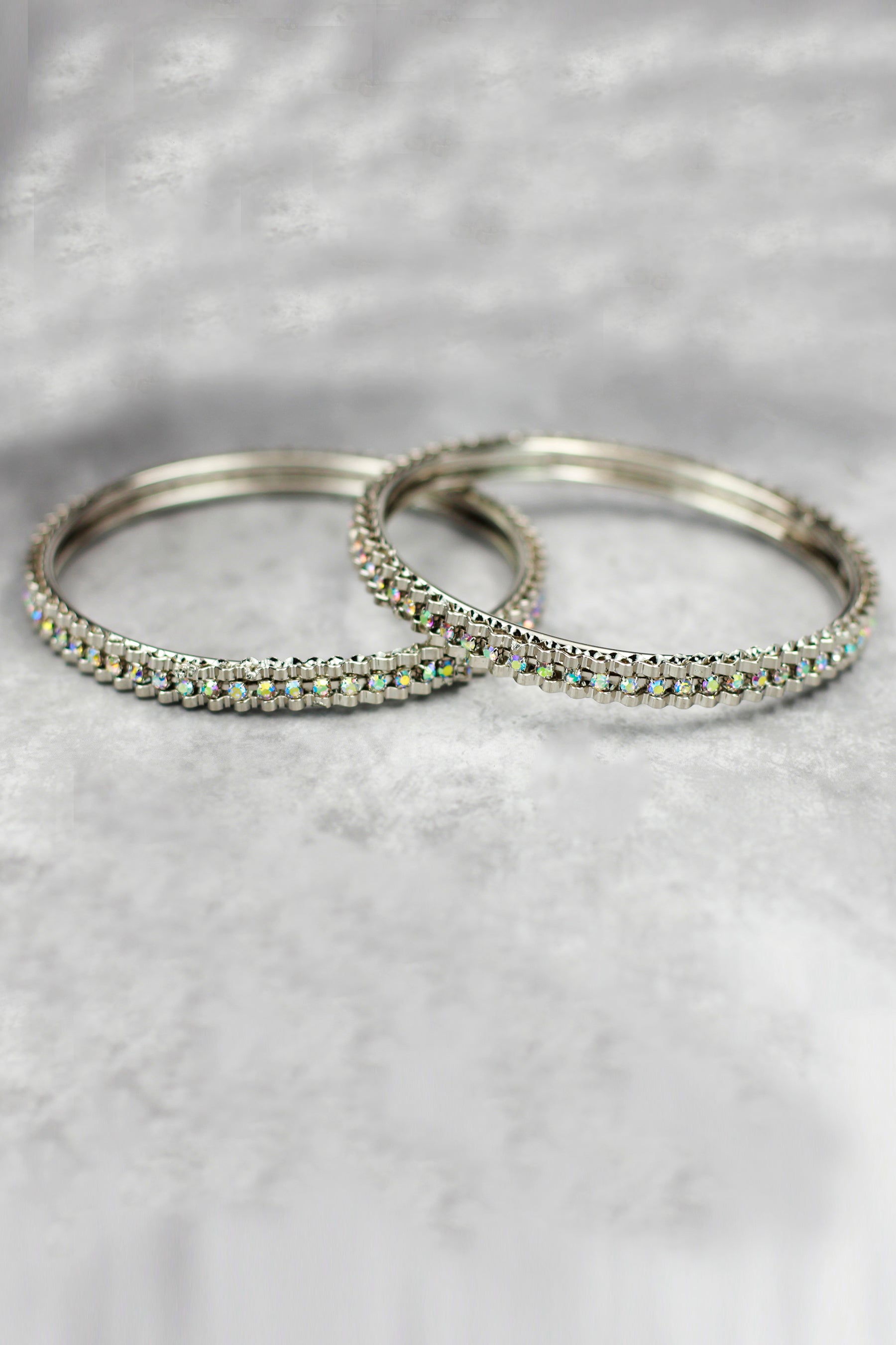 Silver-tone crystal bangles with sleek sparkle, perfect for festive wear, parties, and elegant ethnic styling.