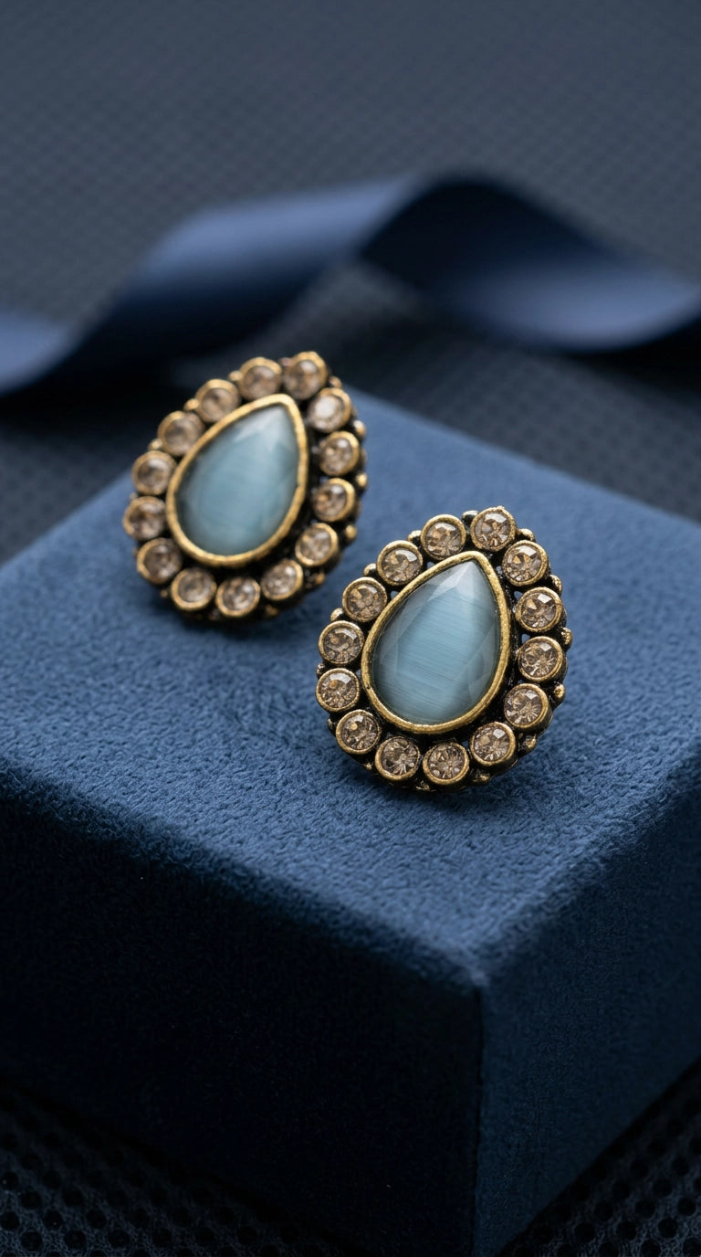 Sea Blue Teardrop Stud Earrings with Gold-Tone Halo and Crystal Accents for Festive Wear