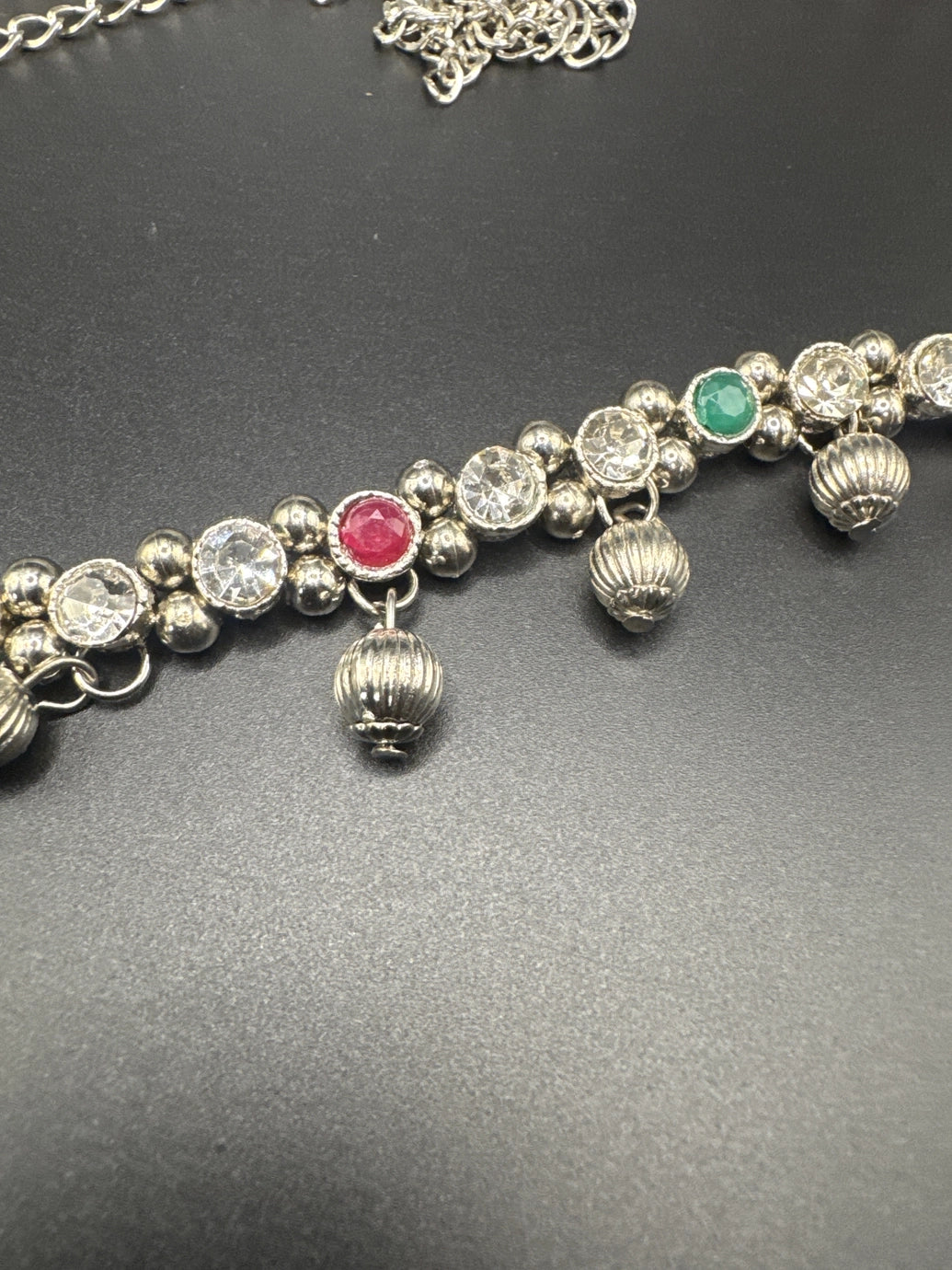 Silver-tone hip chain with oxidized finish, multicolor imitation stone accents, and ghungroo bell detailing, elegant traditional design with