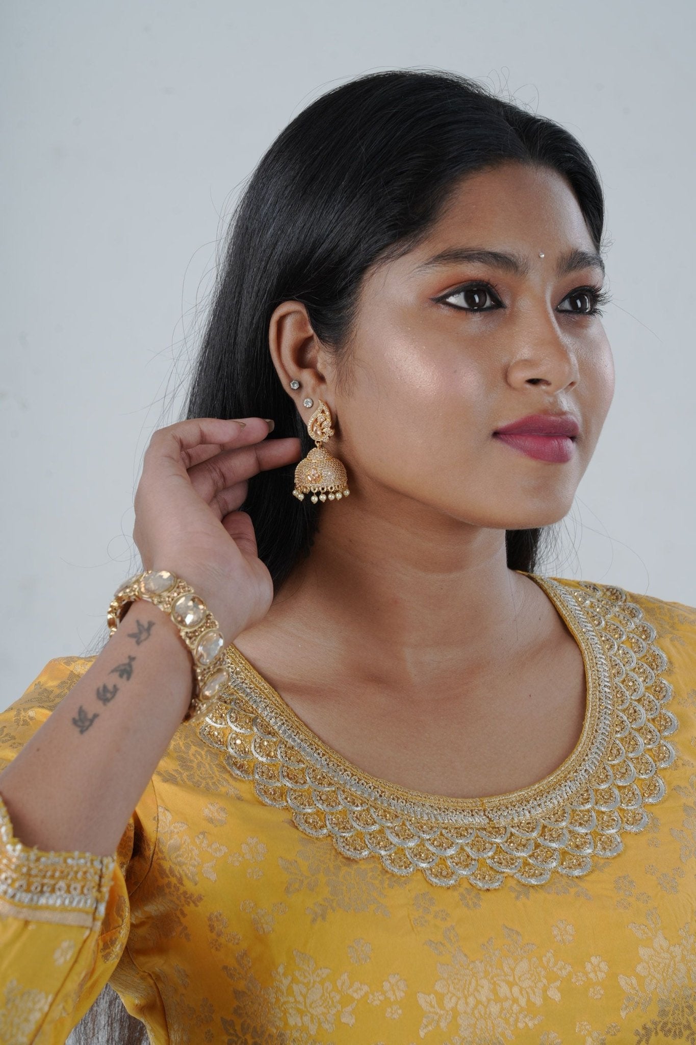Radiant Gold Polish Jhumka Earrings with Elegant White Stones and Pearls Jewelry JCS Fashions