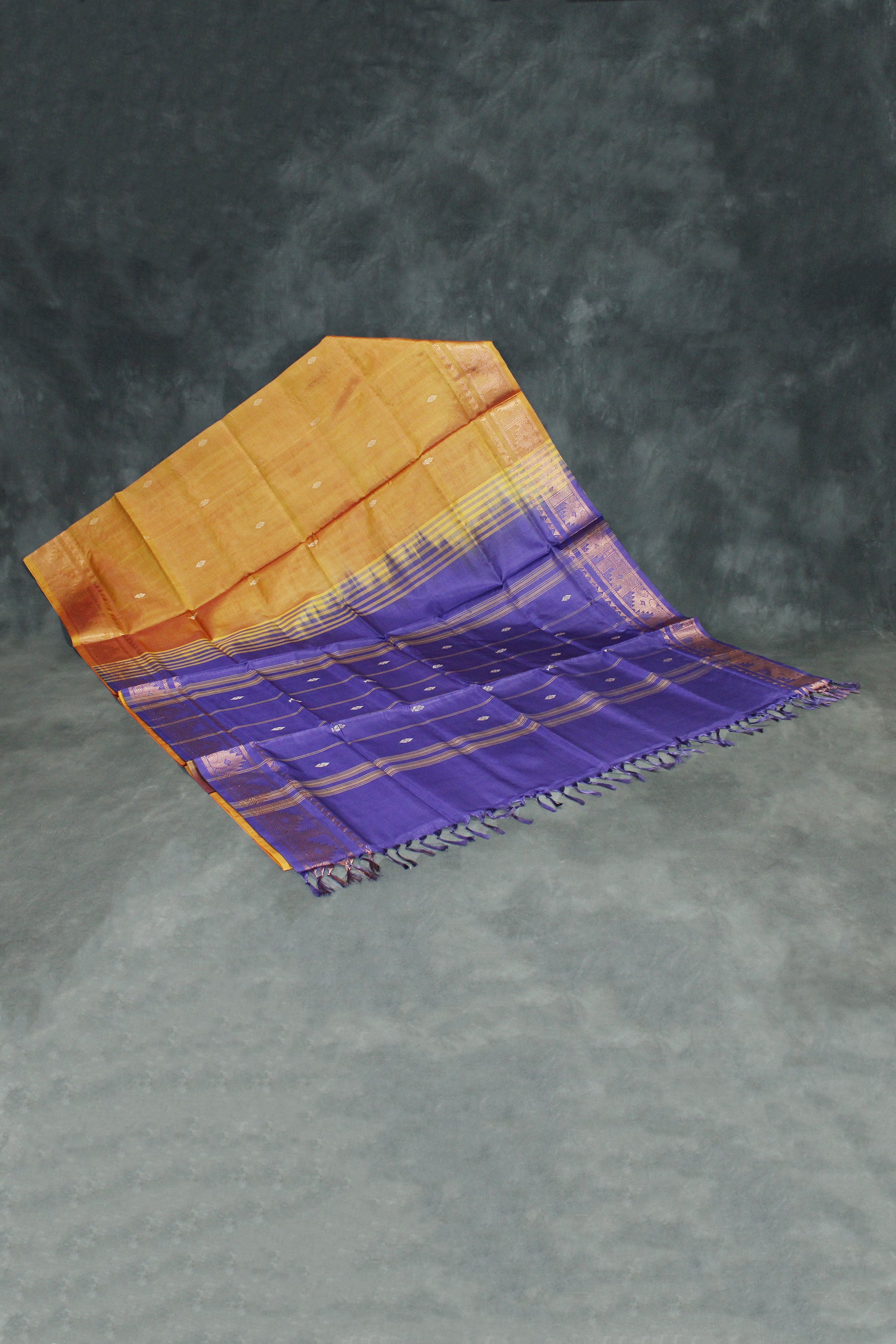 Saree with orange and purple gradient on a gray background