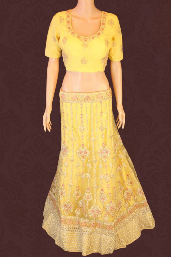 Heavy designer lehenga with embroidery & stone work in a pleasant yellow