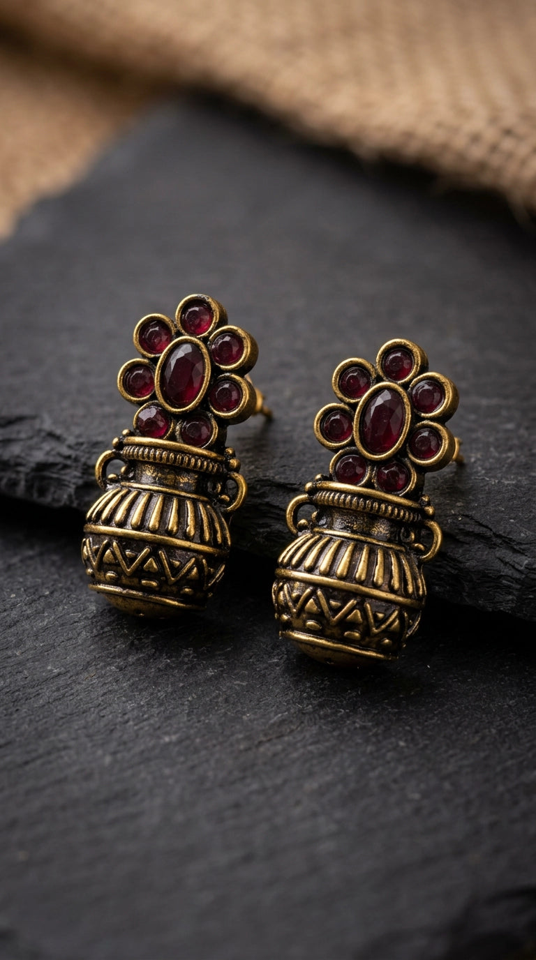 Red Antique Gold-Tone Jhumka Earrings with Floral Stud Design and Red Crystal Stones