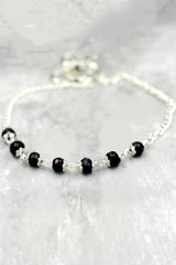 Silver-Plated Traditional Anklet with Black Beads and Flower Charm for Daily Wear and Festive Outfits