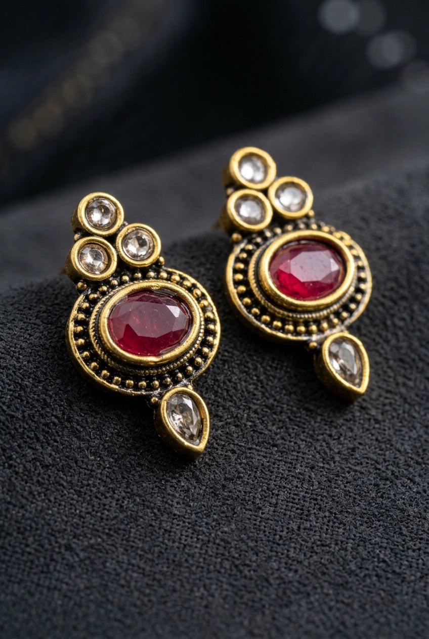 Red Oval Stone Antique Finish Stud Earrings with Gold-Tone Bead Detailing for Traditional & Festive Wear