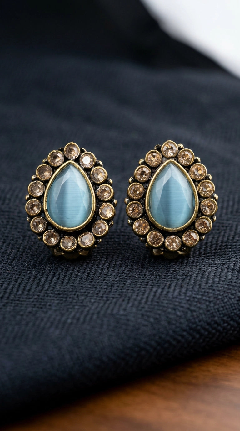 Sea Blue Teardrop Stud Earrings with Gold-Tone Halo and Crystal Accents for Festive Wear