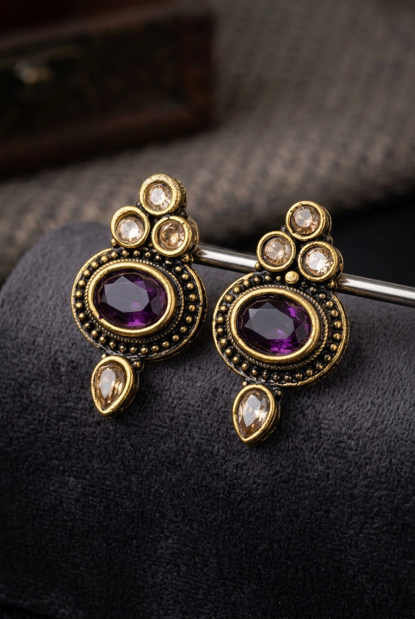 Purple Oval Stone Antique Finish Stud Earrings with Gold-Tone Detailing for Traditional & Festive Wear
