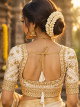 White Zari Padded Designer Blouse with U-Neck, Floral Butta Work, Elbow Sleeves and Back Knot