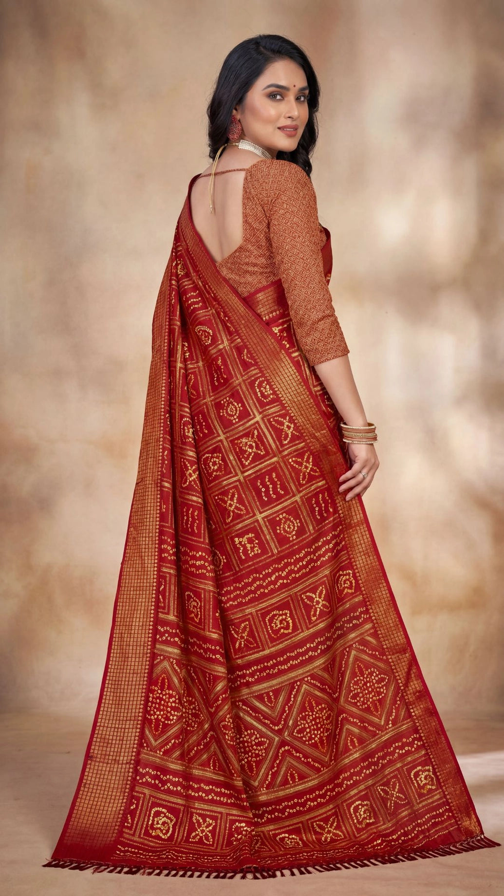 Deep Red Bandhani Chiffon Saree with Gold Zari Motifs and Broad Border for Festive Wear
