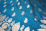 beautifully adorned with intricate zari weaving banarasi saree. The saree features delicate floral and mango motifs woven across the body, c
