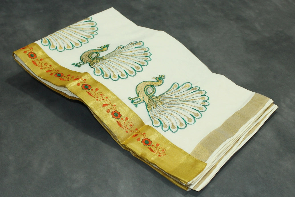 Fabric: Pure Kerala Cotton – lightweight, breathable, 
        •        Design: Rich machine embroidery in Gold zari and thread with detaile