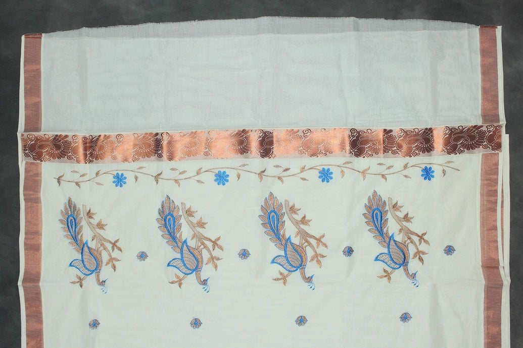 Fabric: Pure Kerala Cotton – lightweight, breathable, 
        •        Design: Rich machine embroidery in Copper zari and thread with detai