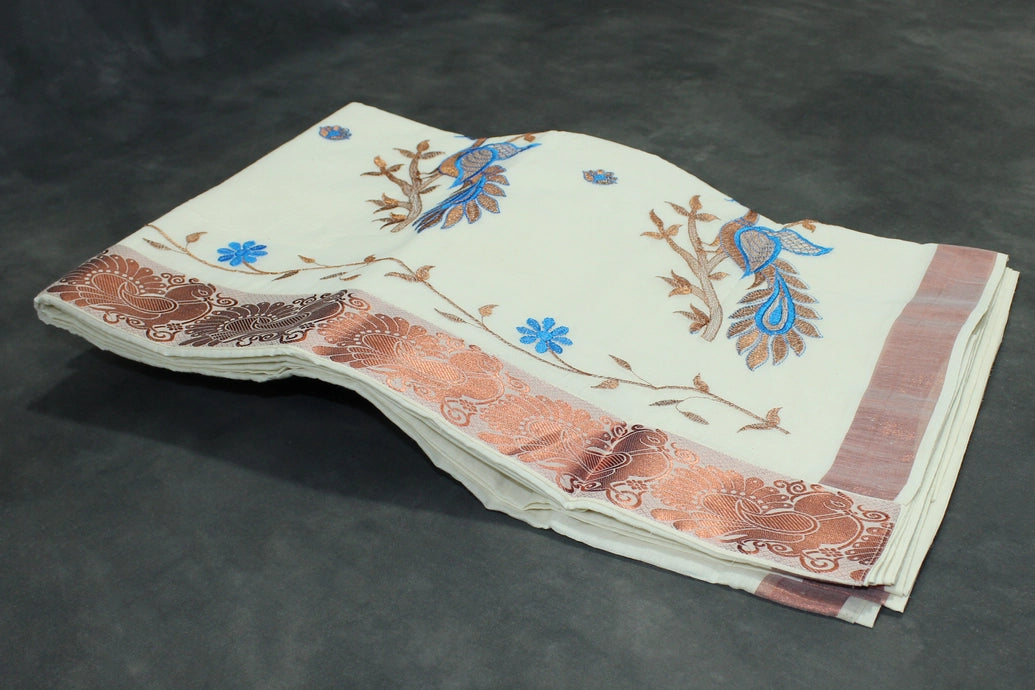 Fabric: Pure Kerala Cotton – lightweight, breathable, 
        •        Design: Rich machine embroidery in Copper zari and thread with detai