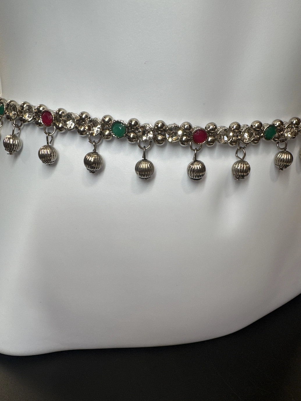 Silver-tone hip chain with oxidized finish, multicolor imitation stone accents, and ghungroo bell detailing, elegant traditional design with