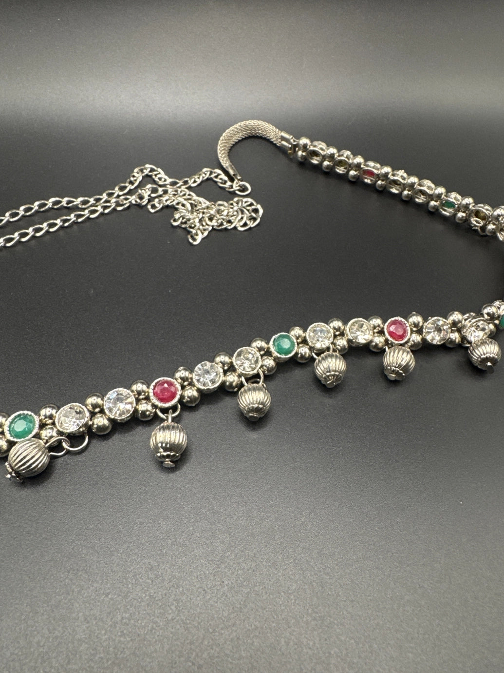 Silver-tone hip chain with oxidized finish, multicolor imitation stone accents, and ghungroo bell detailing, elegant traditional design with