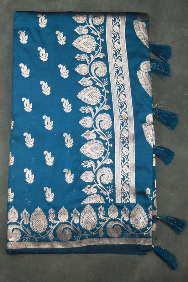 beautifully adorned with intricate zari weaving banarasi saree. The saree features delicate floral and mango motifs woven across the body, c - Peacock Blue
