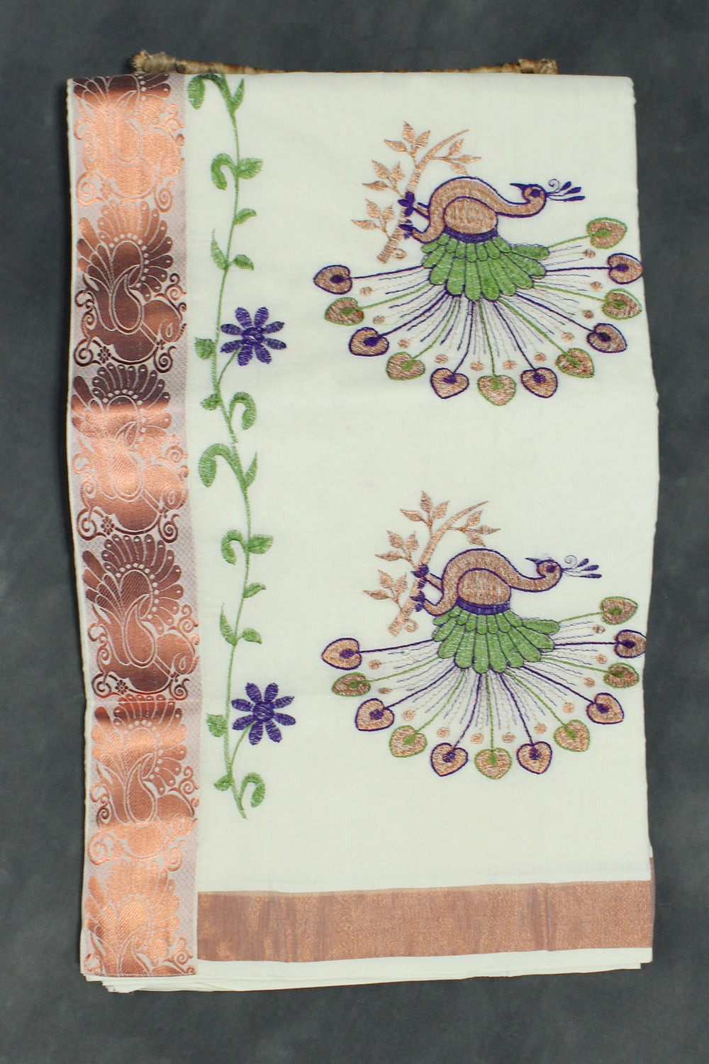 Fabric: Pure Kerala Cotton – lightweight, breathable, 
        •        Design: Rich machine embroidery in Copper zari and thread with detai - White