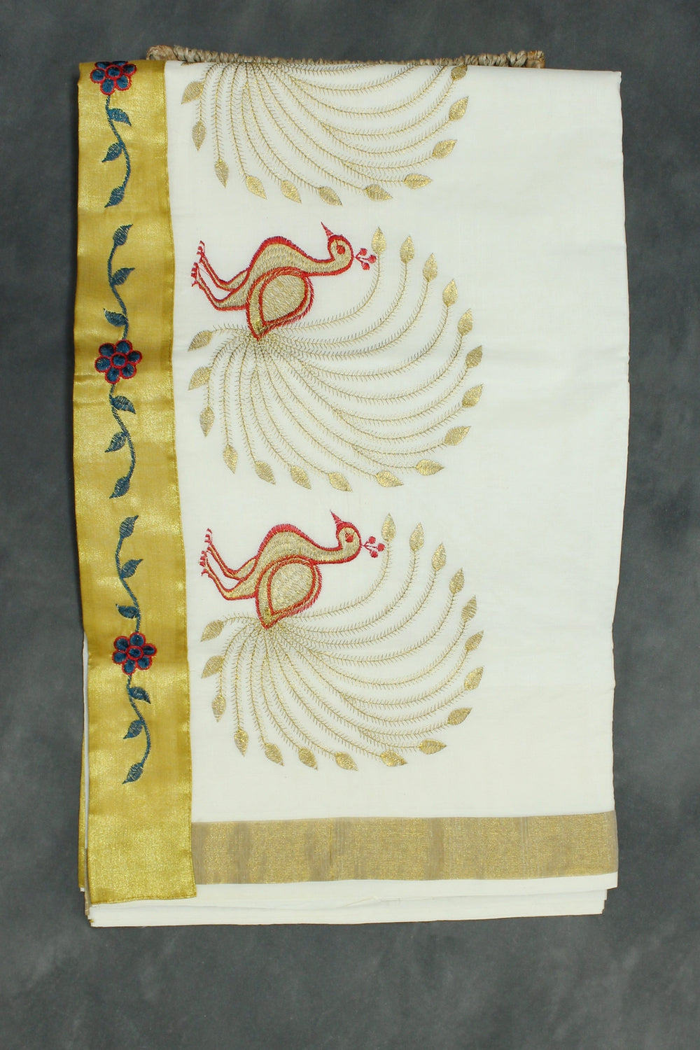 Fabric: Pure Kerala Cotton – lightweight, breathable, 
        •        Design: Rich machine embroidery in Gold zari and thread with detaile - White